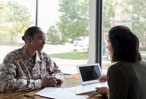 Woman in military outfit completing a job interview